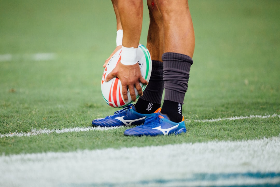 Rugby Training for Beginners cover with a rugby ball, cones, boots, and a marked pitch